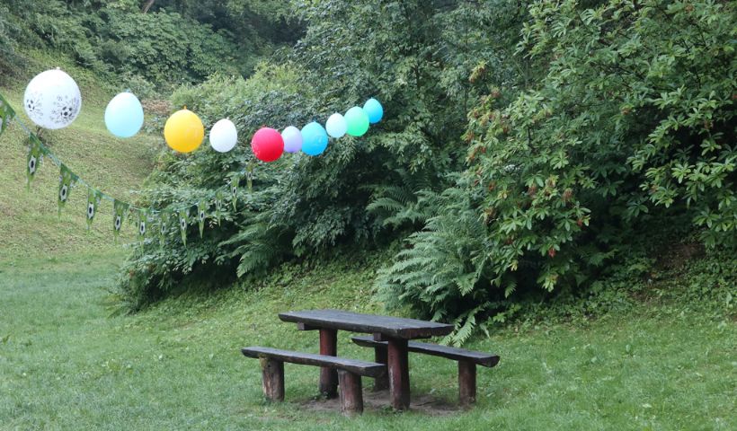 Birthday decoration in open garden with balloons, banner for happy birth images for a friends.